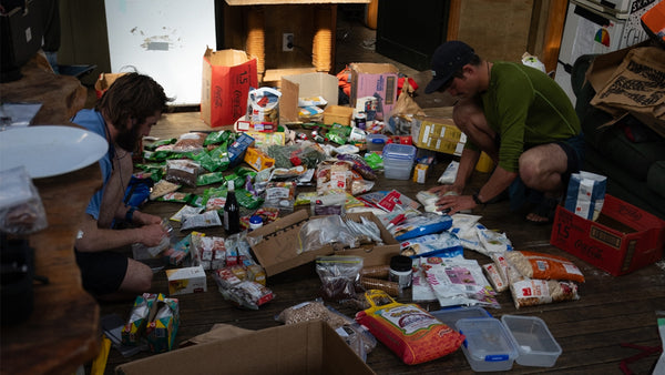 Paddlers planning their food supply for an expedition kayaking trip.