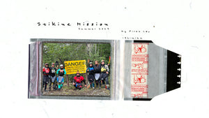 Group of kayakers standing infront of warning sign at the stikine river.