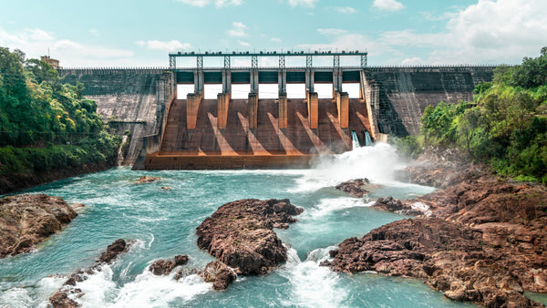 Looking at the Kopili River dam from down stream while blue water flows out