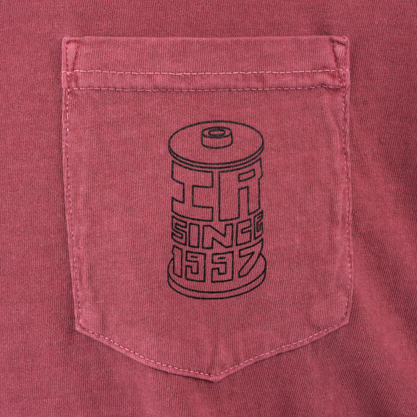 Red shirt pocket with black spool design and 'IR Since 1997' text.