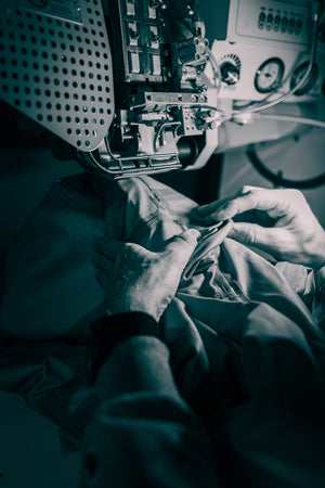 A tape machine repairing a leaking dry suit.