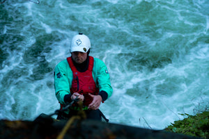 Kayaker, Benny Marr, portaging a rapid in a Devils Club dry suit from Immersion Research.