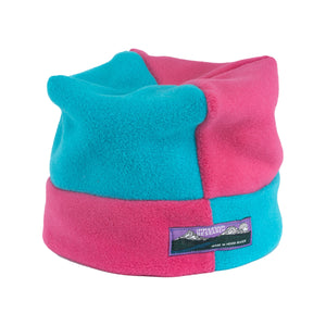 Two-toned pink and blue fleece beanie with a brand label on a white background