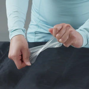 Gear Aid Tenacious Tape Flex Patches being slightly stretched before use
