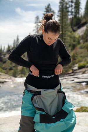 Women putting on performance base layers for whitewater kayaking and rafting.