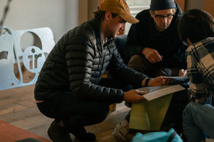 Three product developers looking at fabric for Immersion Research dry wear.