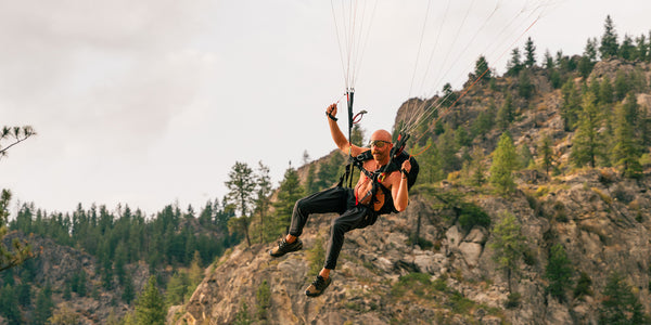 A man paragliding shirtless in Fancy Pants by Immersion Research.