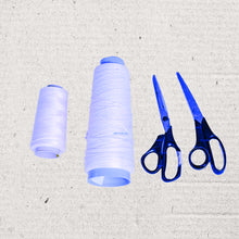 Image of two rolls of thread and two sets of scissors.