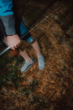 a paddler holding a paddle wearing immersion research board shorts 