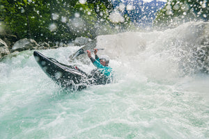 a whitewater paddler skipping out of a drop on the soca river.