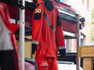 An Immersion Research search and rescue dry suit hanging up at a task force HQ.