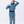 A women walks into the frame and tries on an Aphrodite dry suit by Immersion Research to see how it fits.